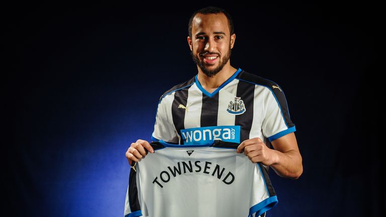 New signing Andros Townsend poses for photographs holding a named shirt at The Newcastle United Training Centre