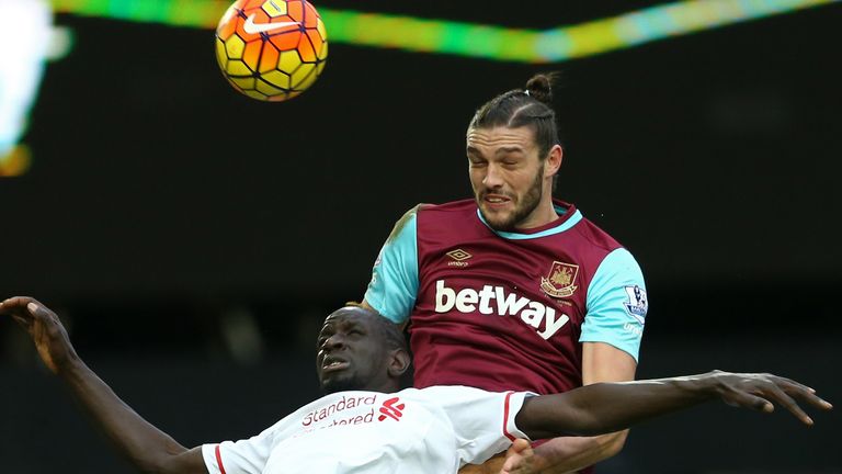  Andy Carroll wins a header against Liverpool's Mamadou Sakho