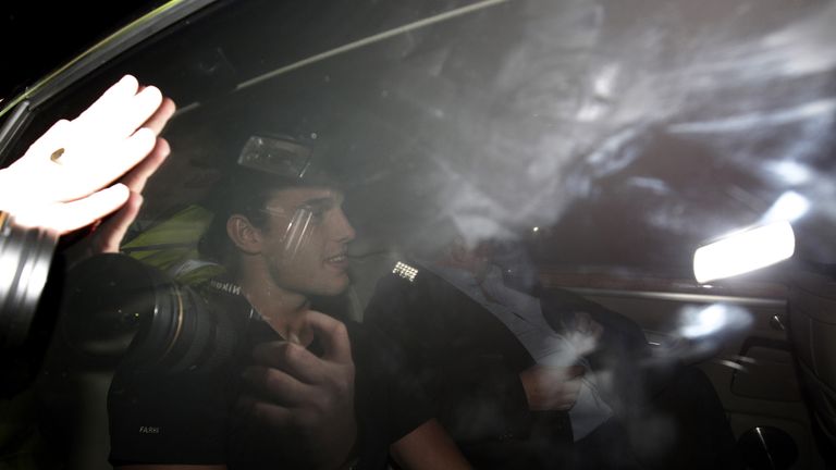 Photographers train their cameras on the car in which Newcastle United forward Andy Carroll arrives at Liverpool's Melwood training ground