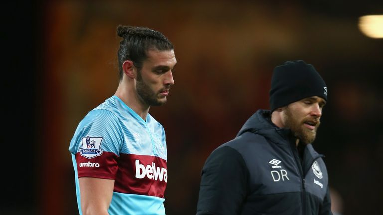 An injured Andy Carroll of West Ham United leaves the pitch