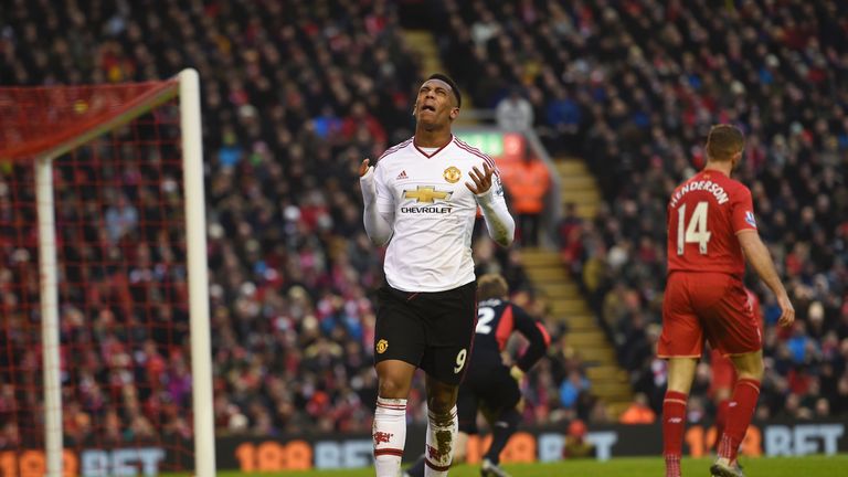 Manchester United's French striker Anthony Martial (C) reacts