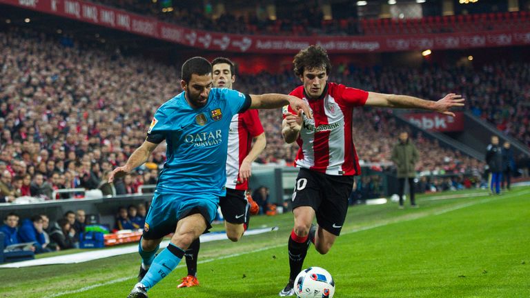 Arda Turan of FC Barcelola duels for the ball with Inigo Lekue of Athletic Club