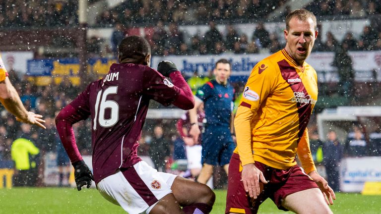 Hearts' Arnaud Djoum (left) is brought down by Motherwell's David Clarkson to win a penalty