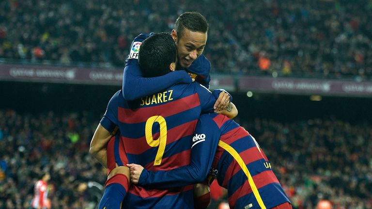 Barcelona's Uruguayan forward Luis Suarez (L) celebrates with Barcelona's Brazilian forward Neymar (top) after 