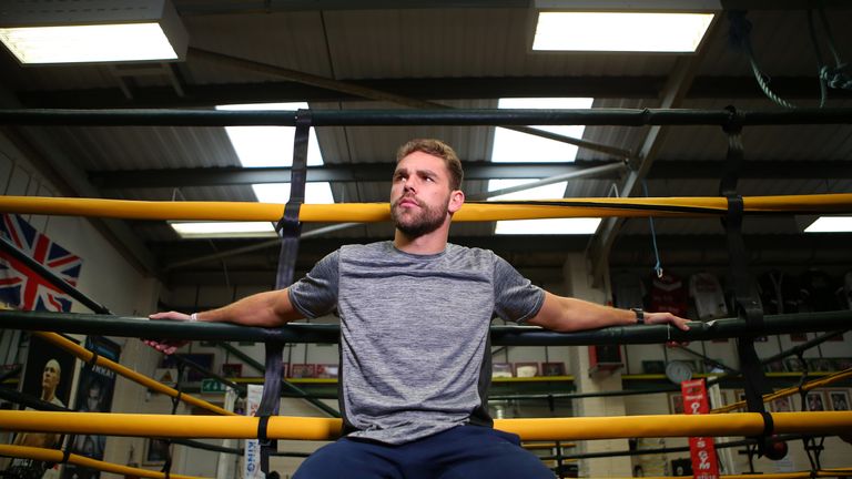 SALFORD, ENGLAND - DECEMBER 14: Boxer Billy Joe Saunders gives a television interview during a media work-out at Oliver's Gym on December 14, 2015 in Salfo