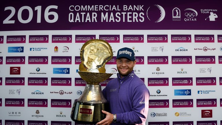 Branden Grace lifts the huge Qatar Masters trophy for the second year running