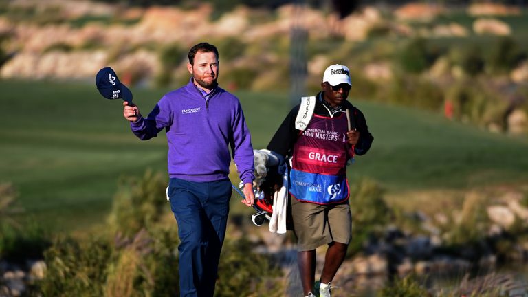 Grace salutes the galleries after his towering three-iron to the heart of the green at the last