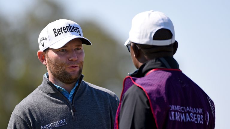 DOHA, QATAR - JANUARY 29:  Branden Grace of South Africa chatting to his caddie Zacharia Rasego on the first green during the third round of the Commercial