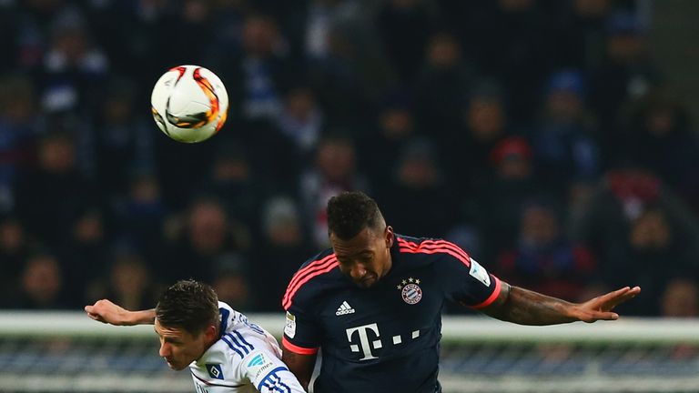 Ivo Ilicevic of Hamburg jumps with Jerome Boateng of Bayern Munich