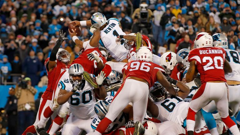 Newton dives over the pile to score from a yard and put Carolina 24-7 ahead