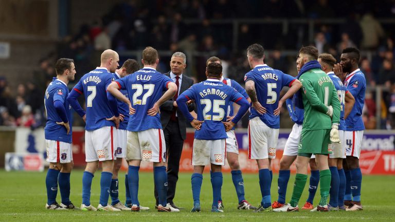 Carlisle manager Keith Curle (C) speaks to his players after the final whistle of the FA Cup game against Everton