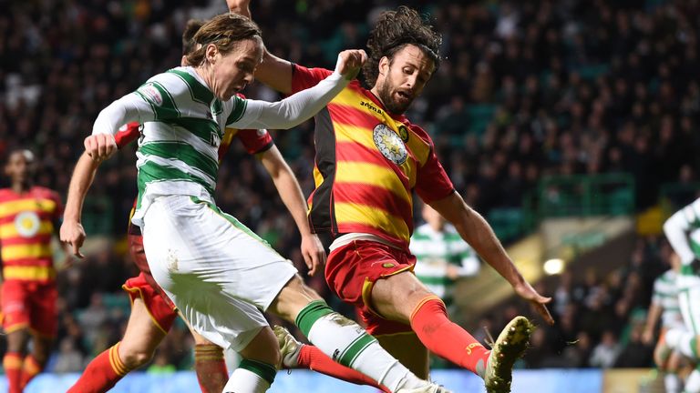 Partick Thistle's Dan Seaborne puts in a block on Stefan Johansen of Celtic