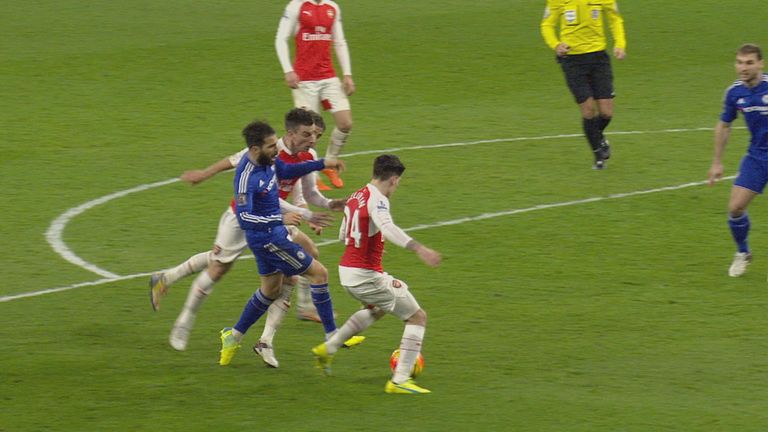 Cesc Fabregas is challenged by Laurent Koscielny in the penalty area
