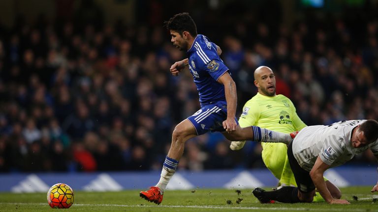 Chelsea striker Diego Costa goes around Everton's goalkeeper Tim Howard to score their first goal