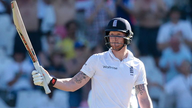 England batsman Ben Stokes (C) raises his bat as he celebrates scoring half century