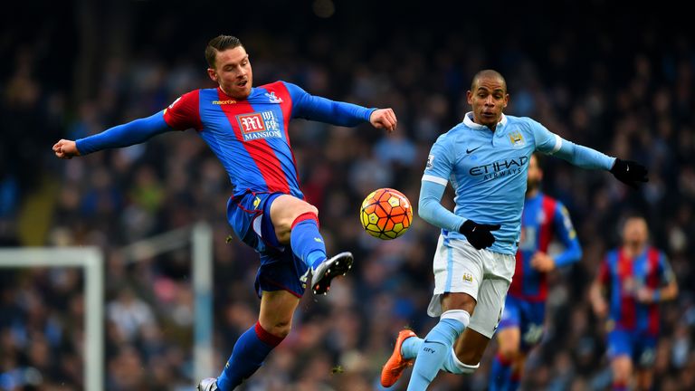 Connor Wickham of Crystal Palace attempts to control the ball under pressure from Fernando of Manchester City 