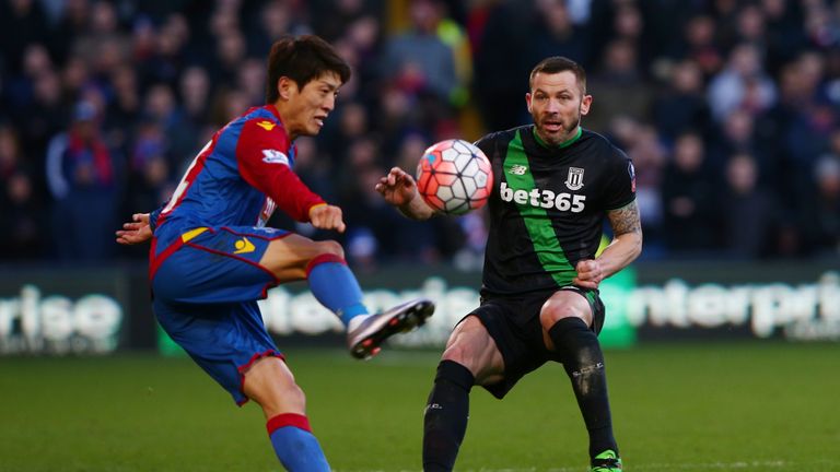 Phil Bardsley of Stoke City and Lee Chung-yong of Crystal Palace compete for the ball 