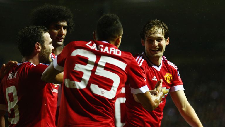 Daley Blind of Manchester United (R) celebrates withJesse Lingard (35) and team mates 