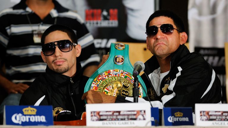 LAS VEGAS, NV - JULY 12:  Boxer Danny Garcia (L) and his father and trainer Angel Garcia hold up the younger Garcia's  WBC super lightweight belt during th