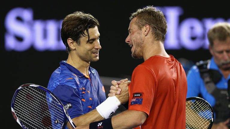 David Ferrer of Spain and Lleyton Hewitt of Australia meet at the net following their second round match