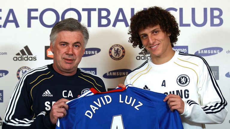 David Luiz of Chelsea is presented his shirt by Chelsea manager Carlo Ancelotti during a press conference at Cobham
