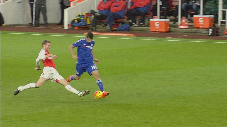 Per Mertesacker fouls Diego Costa during Arsenal's clash with Chelsea.