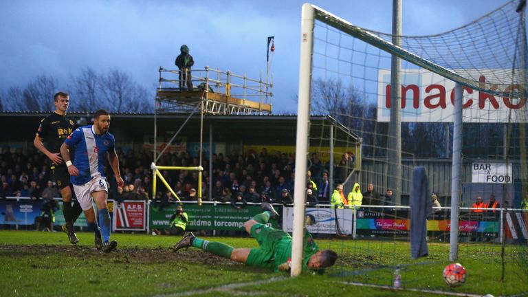 Ben Amos of Bolton Wanderers fails to stop the Eastleigh's first goal scored by Dorian Dervite