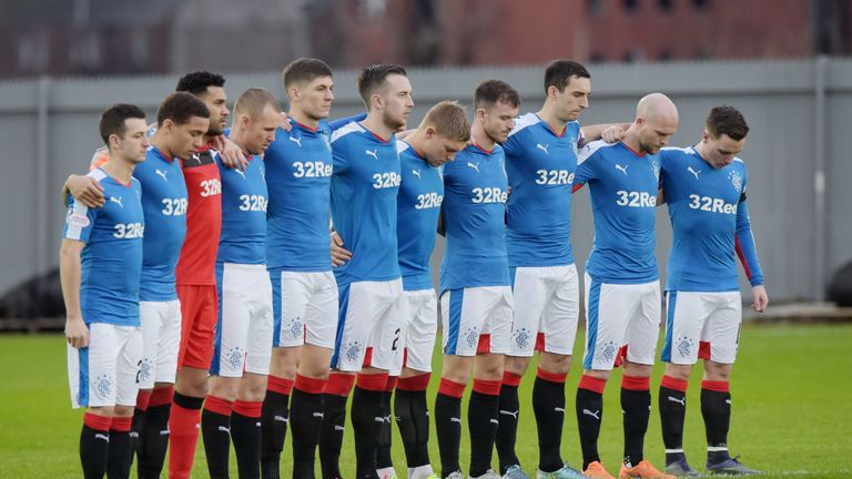 .The Rangers players observe a minute's silence to remember those who lost their lives in the 1971 Ibrox Disaster.