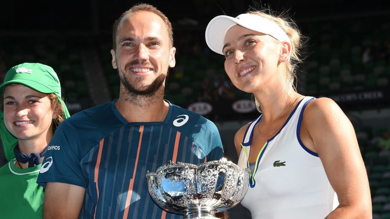 Elena Vesnina of Russia (R) and partner Bruno Soares of Brazil pose with the trophy after winning the Australian Open mixed doubles