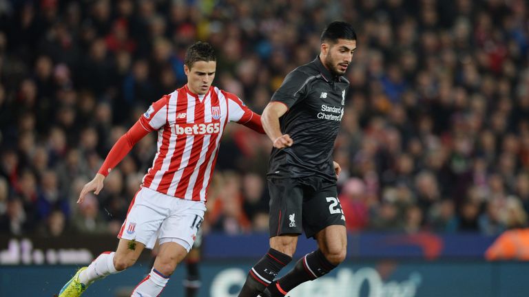 Emre Can is challenged by Ibrahim Afellay