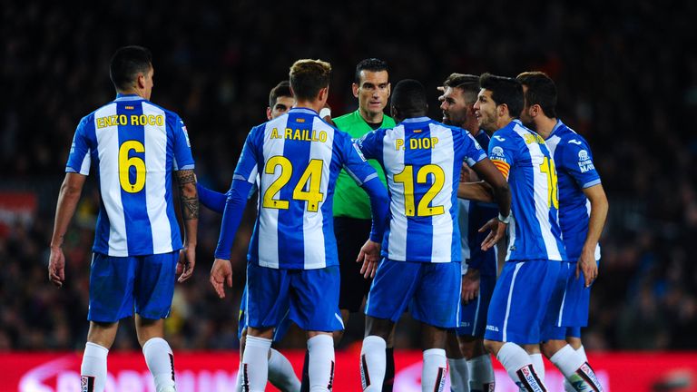 Espanyol players argue with referee Juan Martinez Munuera