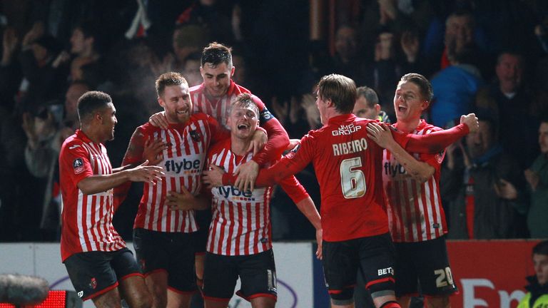 Exeter City's Lee Holmes celebrates with teammates after scoring his sides second goal of the game during the Emirates FA Cup, third round match at St Jame