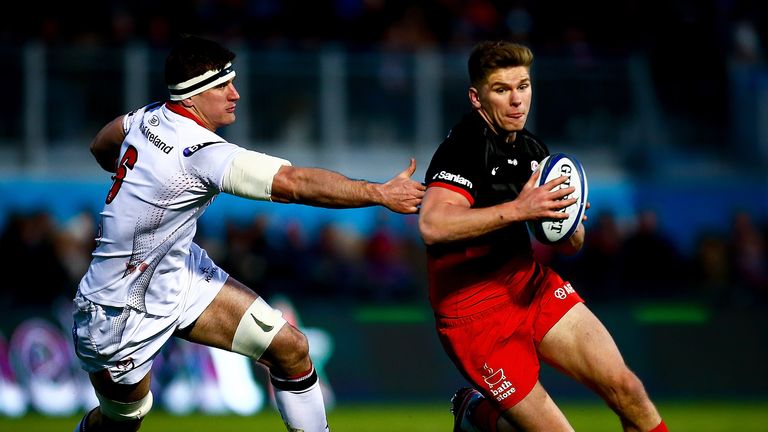 Owen Farrell of Saracens avoids a tackle from Robbie Diack of Ulster during the sides' European Rugby Champions Cup match