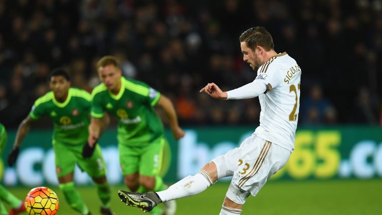 Gylfi Sigurdsson of Swansea converts the penalty to score his team's first goal against Sunderland