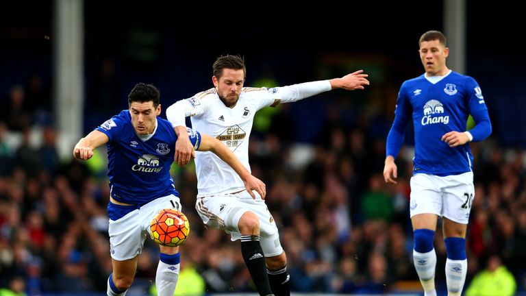 Scorers Gareth Barry and with Gylfi Sigurdsson challenge each other