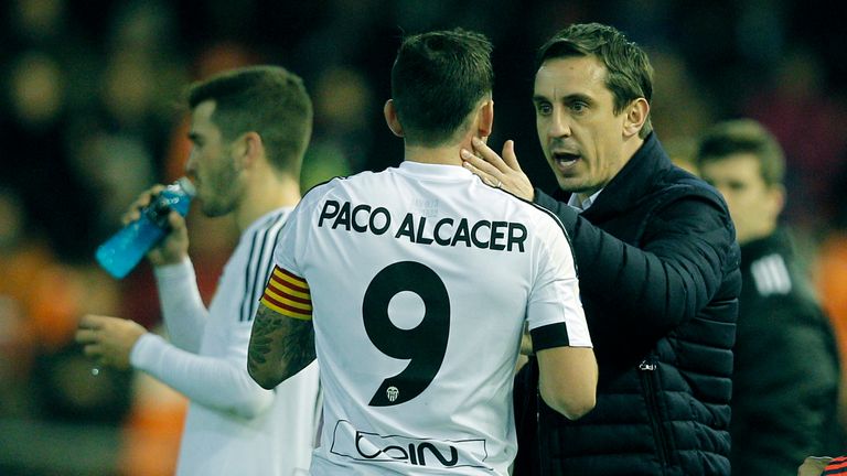 Gary Neville (R) speaks with Valencia's forward Paco Alcacer 