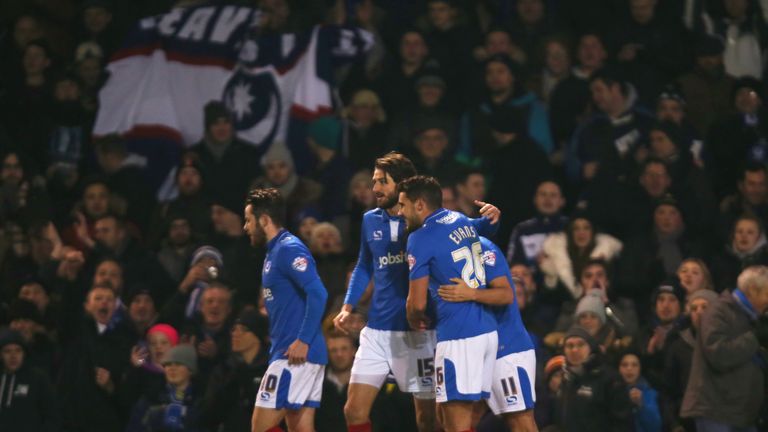 Gary Roberts is mobbed by his Portsmouth team-mates after scoring from the penalty spot