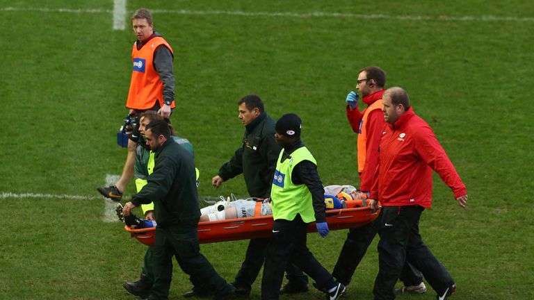 George Kruis is carried off after suffering an injury during Saracens' defeat at Harlequins