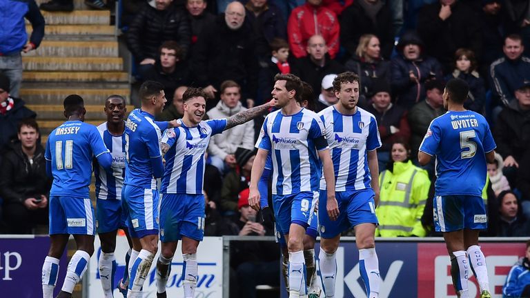 George Moncur (4th L) of Colchester United celebrates scoring his team's first goal
