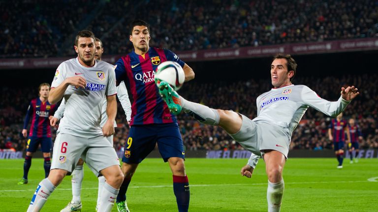 Diego Godin (R) of Club Atletico de Madrid plays the ball next to his teammate Jorge Resurreccion 'Koke' (L) and Luis Suarez of FC Barcelona