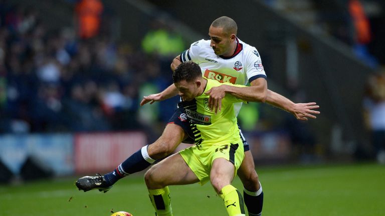 Harry Bunn of Huddersfield Town is challenged by Darren Pratley of Bolton