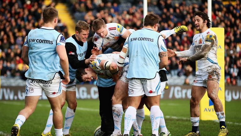 Ian Whitten of Exeter Chiefs is congratulated by team mates after scoring a try
