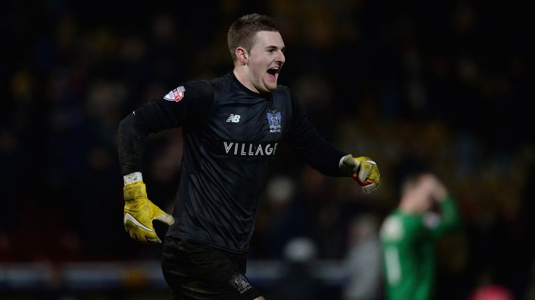 Ian Lawlor celebrates after Bury went through to the fourth round with a penalty shoot-out win over Bradford