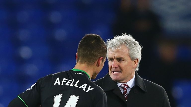 Mark Hughes (R) manager of Stoke City celebrates his team's 4-3 win with his player Ibrahim Afellay (L