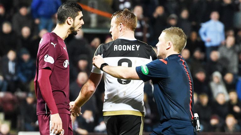 Referee John Beaton pulls Aberdeen's Adam Rooney away from Igor Rossi of Hearts