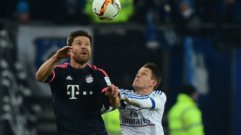 Bayern Munich's Xabi Alonso vies with Hamburg midfielder Ivo Ilicevi 