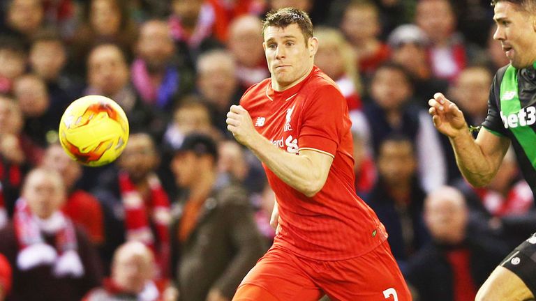 Liverpool midfielder James Milner (left) wins the race for the ball against Stoke