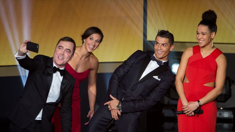 Presenter James Nesbitt (L) takes a photo with (L-R) Carli Lloyd, Cristiano Ronaldo and Celia Sasic, FIFA Ballon d'Or Gala