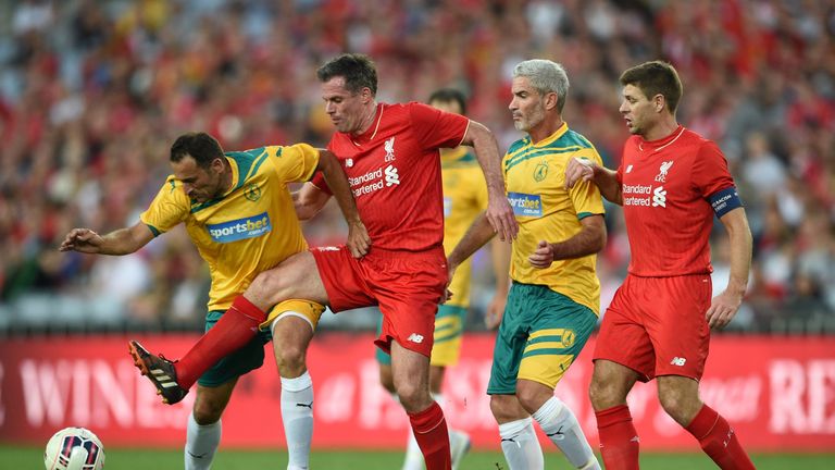 Jamie Carragher fights for the ball with Australian Legends player Tony Vidmar
