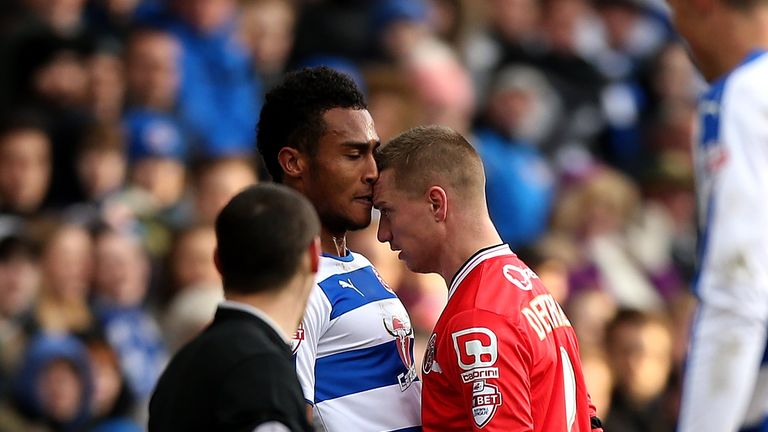 Jordan Obita of Reading and Walsall's Jason Demetriou clash during the FA Cup Fourth Round match between Reading and Walsall
